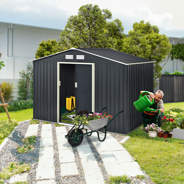 Moderner Geräteschuppen im Garten, Person gießt Blumen mit einer Gießkanne