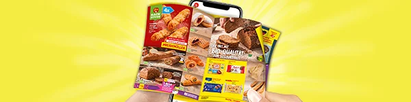 Diese Grafik zeigt auf gelbem Hintergrund mit Strahlen ein Smartphone, vor dem zwei H&auml;nde ein digitales Wochenprospekt mit Backwaren halten; zu sehen sind unter anderem Croissants, Brote, Geb&auml;ck und Produktabbildungen mit den &Uuml;berschriften &bdquo;Preiskn&uuml;ller&ldquo; und &bdquo;Ofenfrische Bio-Qualit&auml;t zum Discountpreis&ldquo;, links oben ein Hinweis auf viermal sowie rechts weitere Prospektseiten, unten ein wei&szlig;er Button mit roter Schrift &bdquo;Zum digitalen Wochenprospekt&ldquo;, der zum Klicken einl&auml;dt.